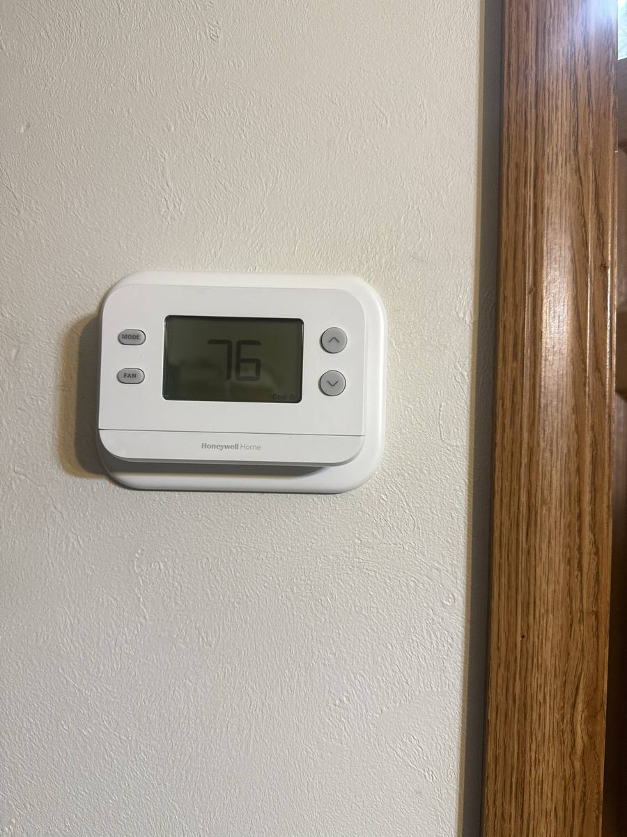 Honeywell Home thermostat installed on an interior wall and set to cooling mode