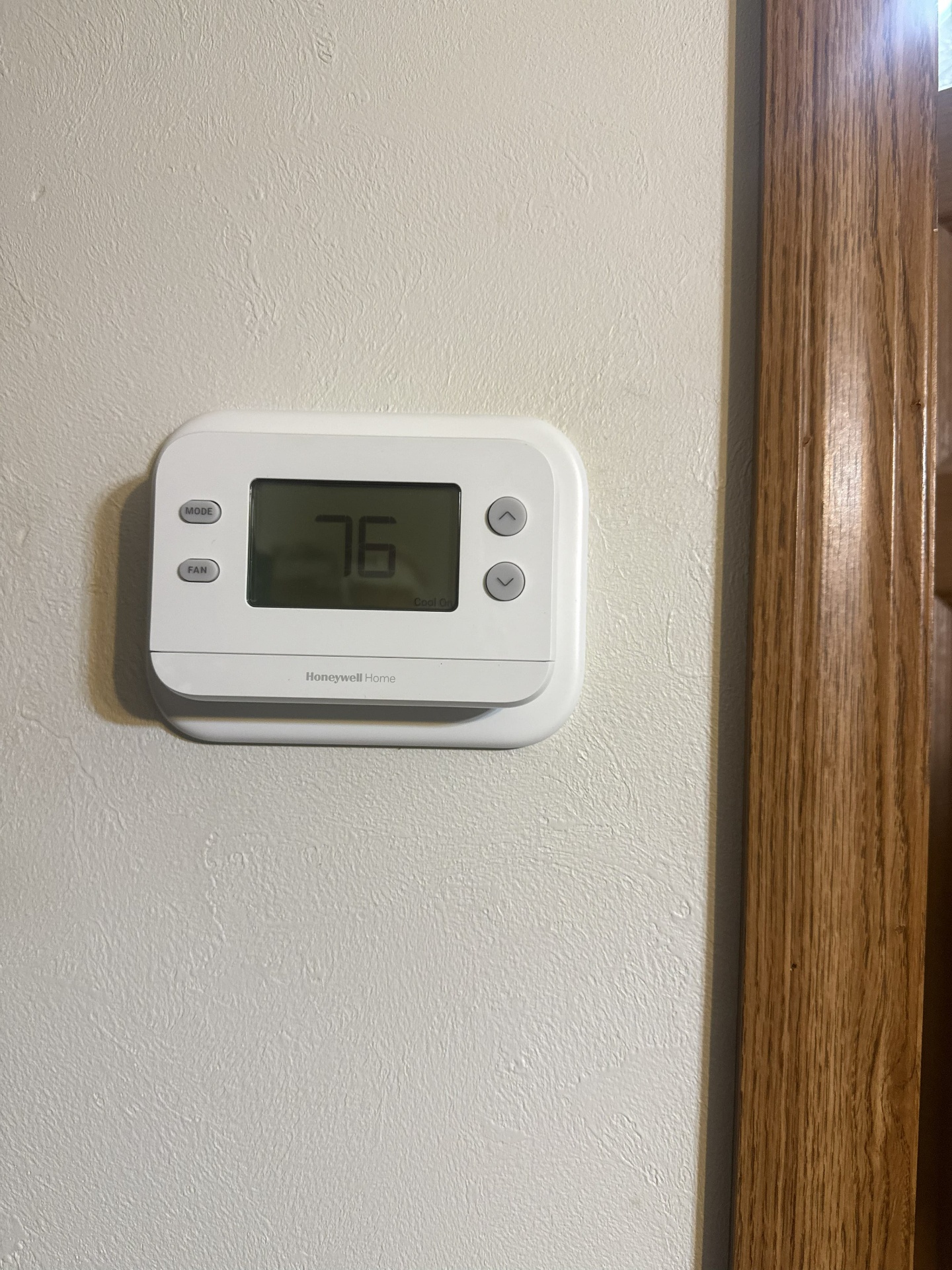 Honeywell Home thermostat installed on an interior wall and set to cooling mode