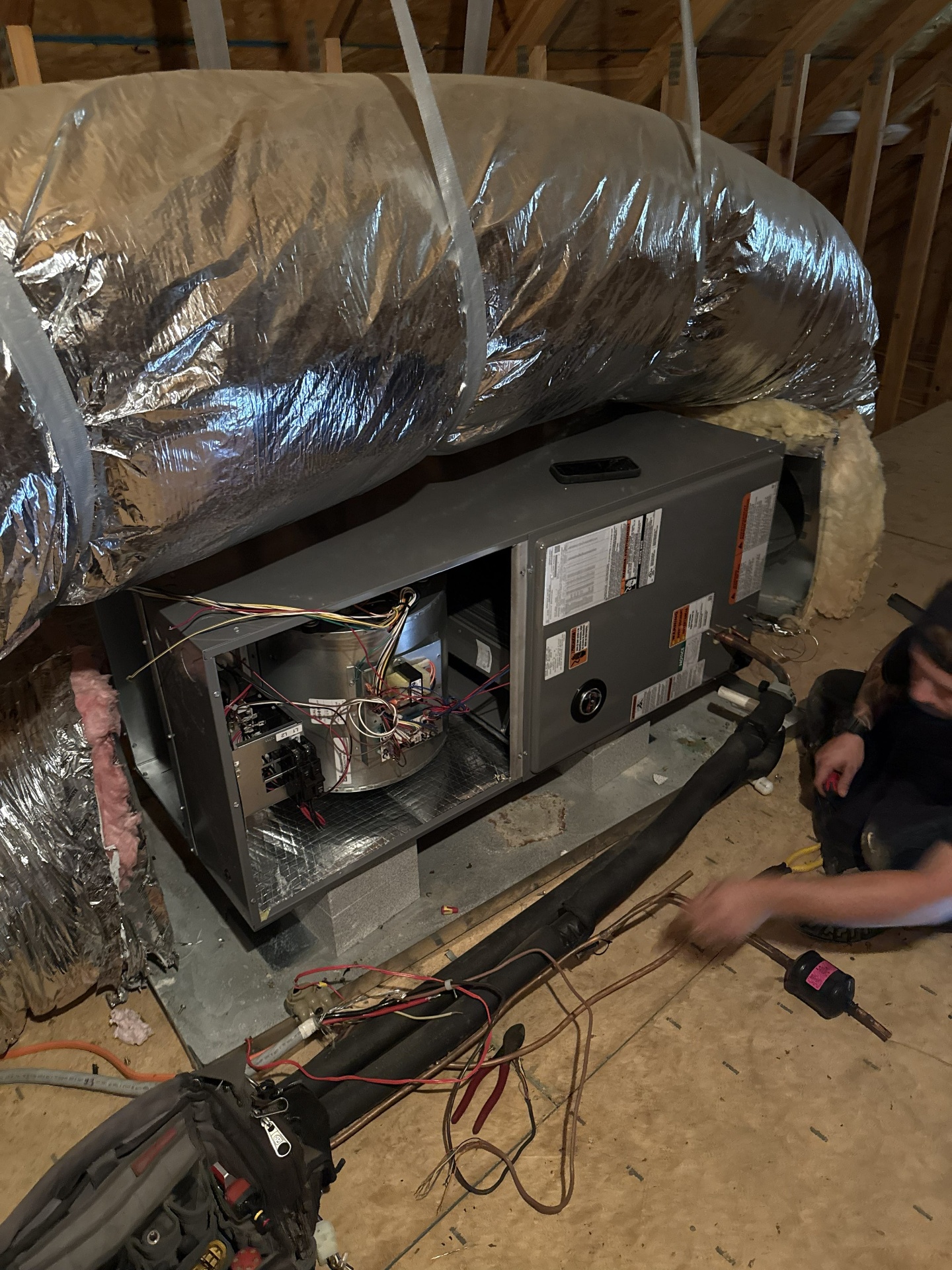 Air handler installation in an attic with insulated flex duct and refrigerant lines